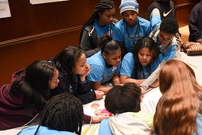 Young people collaborating around a table
