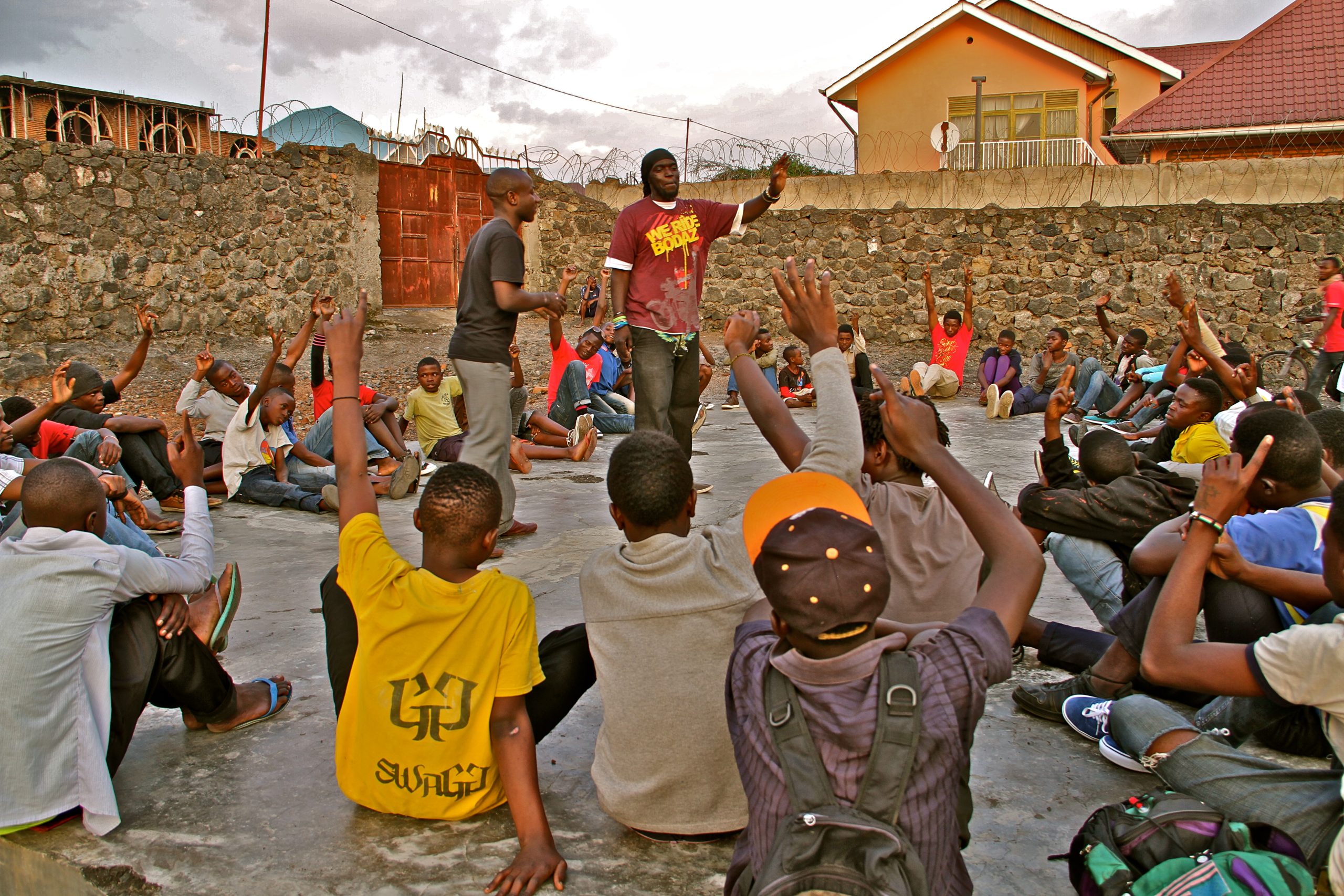 Children raising their hands during an outdoor community activity