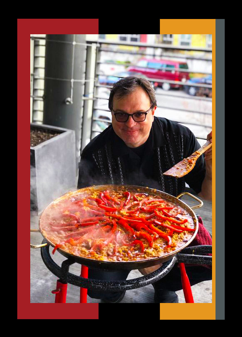 A person preparing food in a large pan